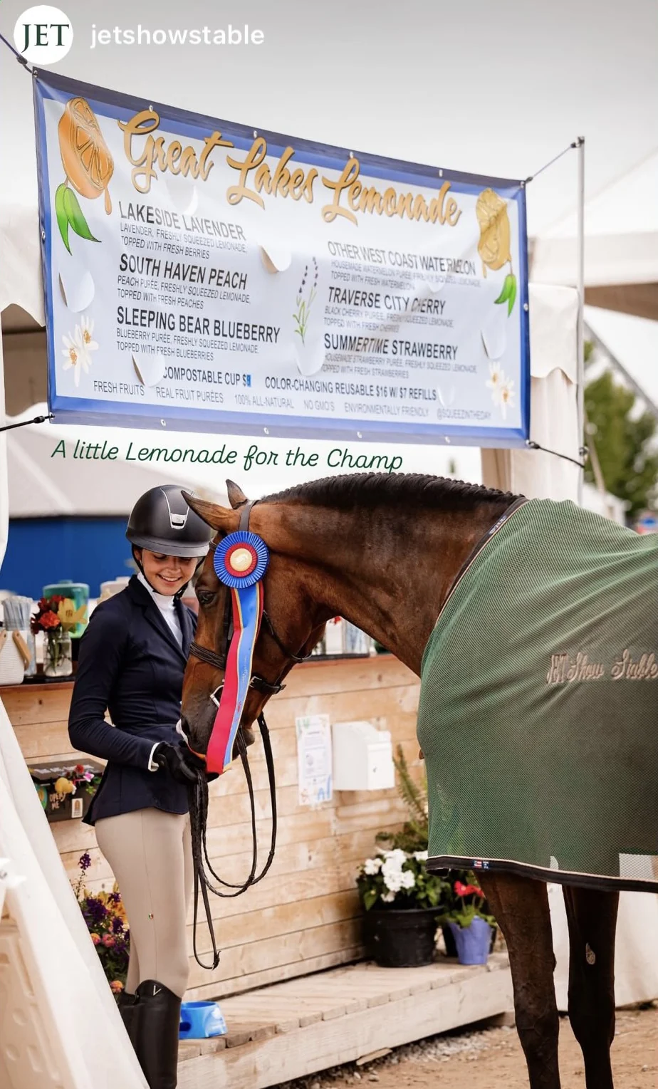 An equestrian and champion horse beside the Great Lakes Lemonade booth