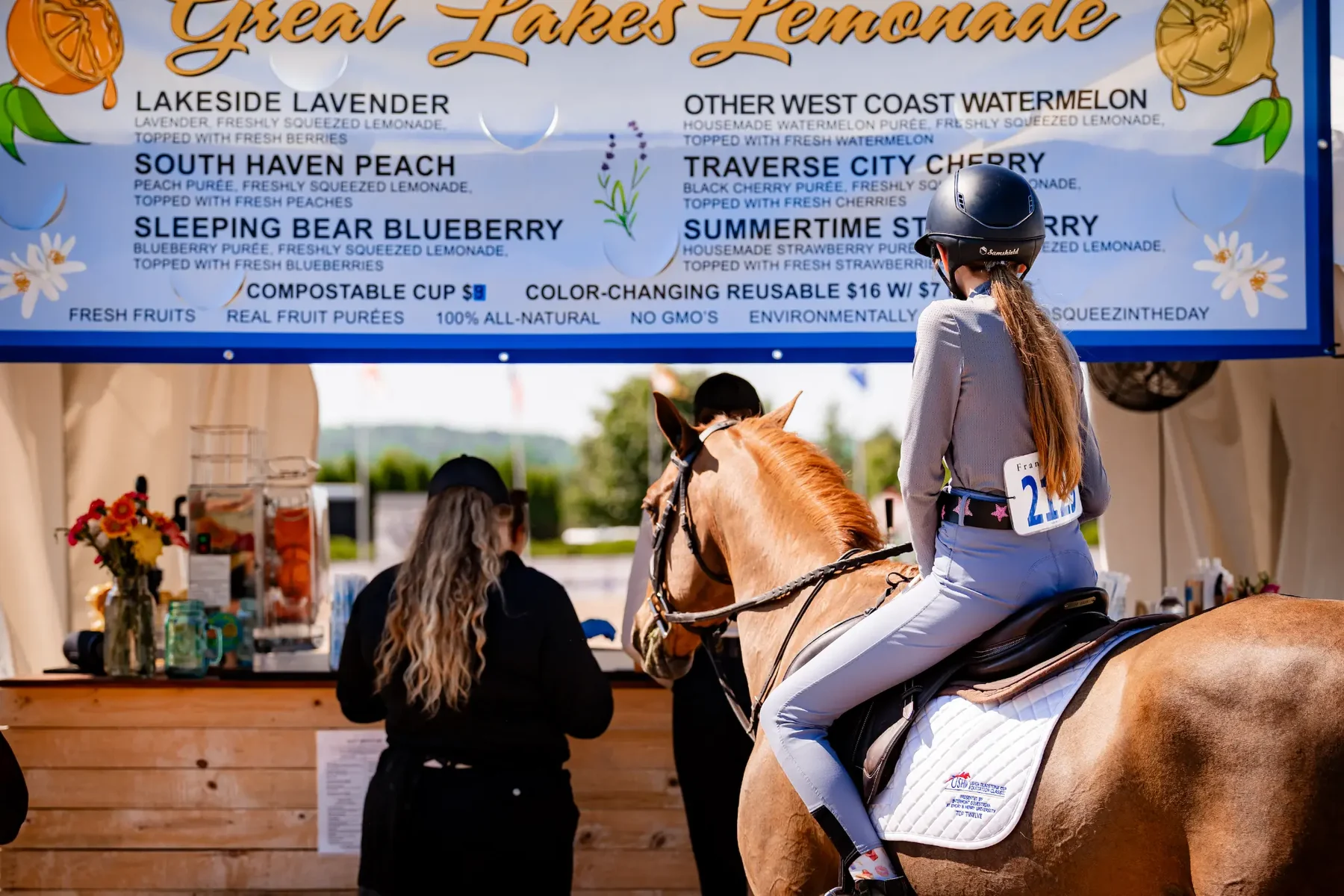 A rider stopping by the Great Lakes Lemonade booth at a horse show